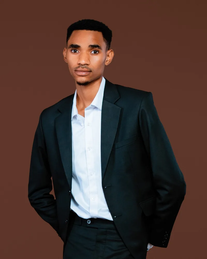 Mazimpaka Jean Baptiste, founder of Oluxy Watches & Wear, in a dark suit and white shirt